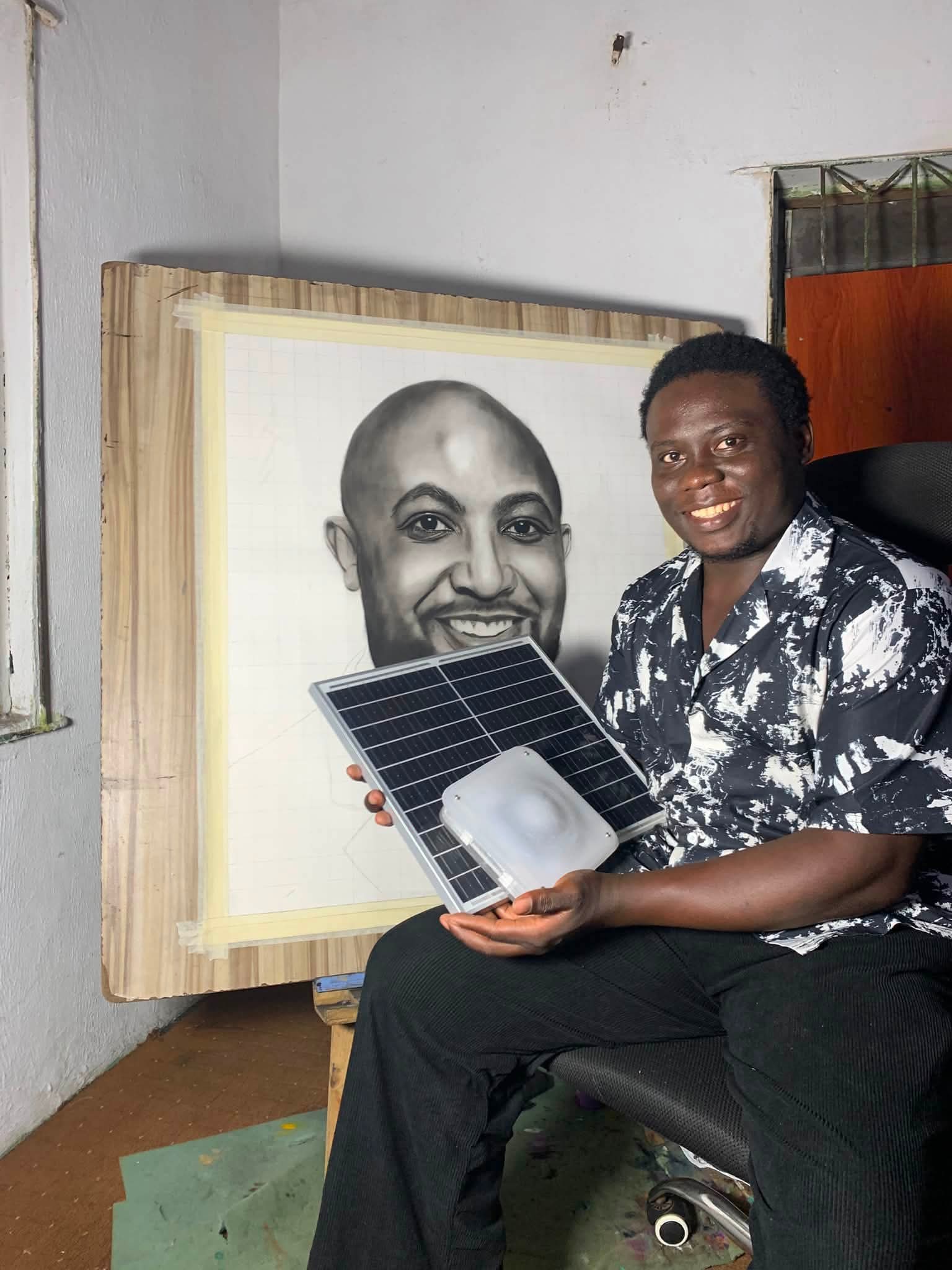 Young artist with a Quadloop solar kit in front of a pencil portrait.