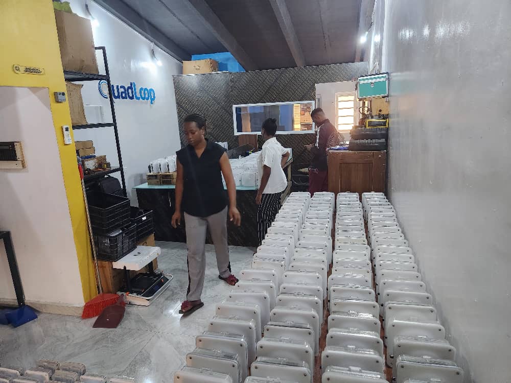Quadloop team members preparing solar lanterns in the workshop