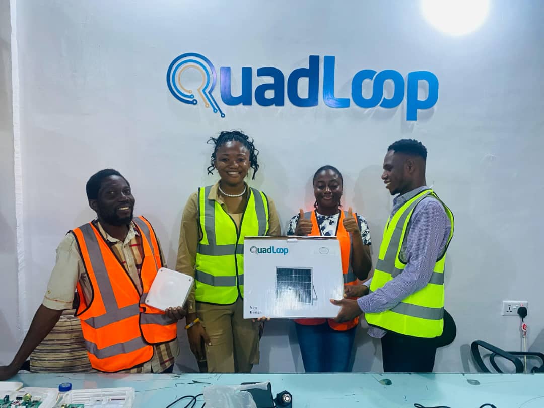Quadloop workshop team with a solar product