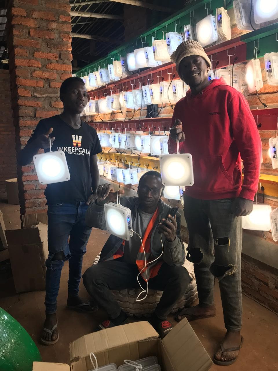 Quadloop team members testing solar lanterns