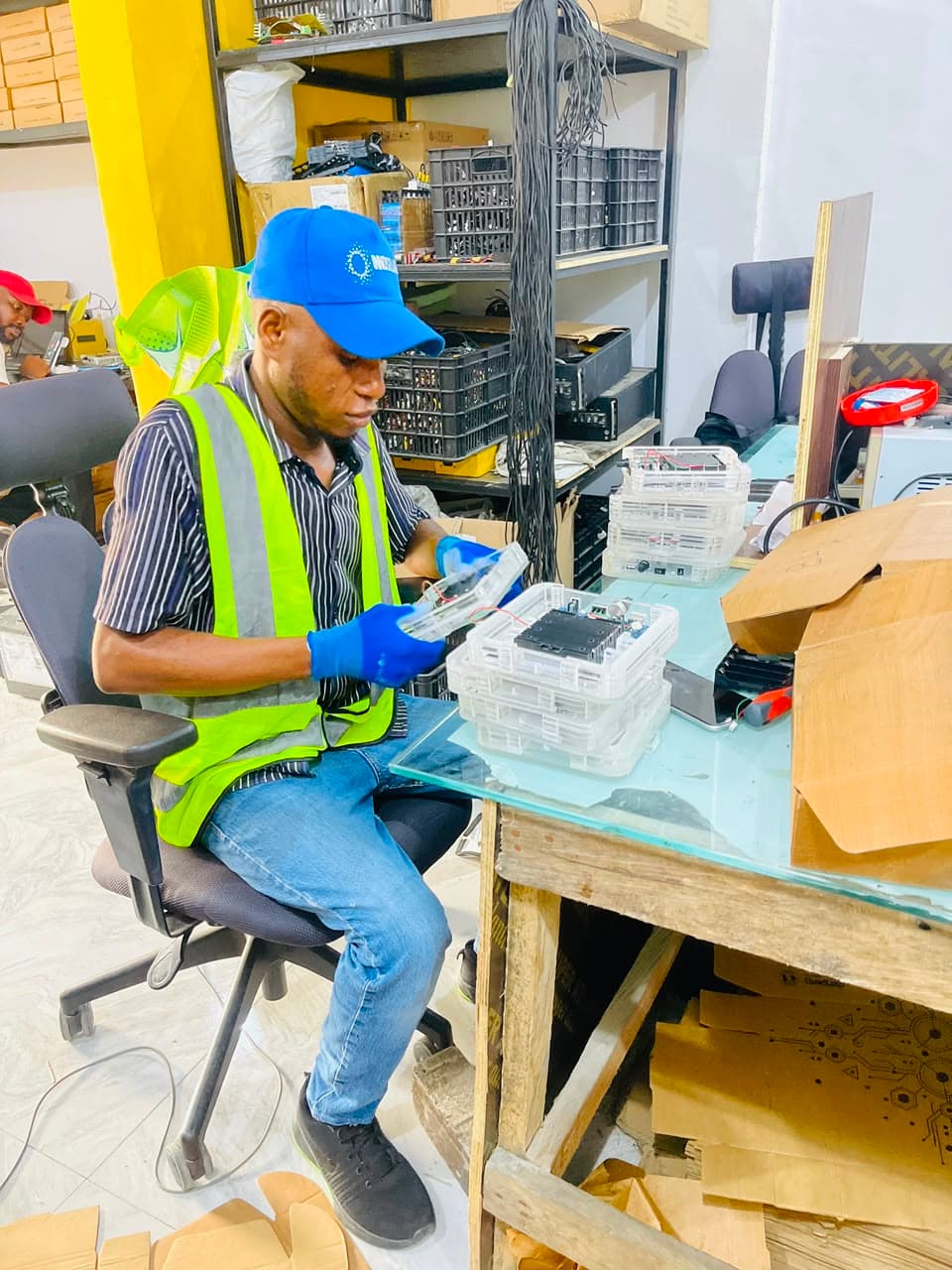 Quadloop technician assessing electronic components at a workbench