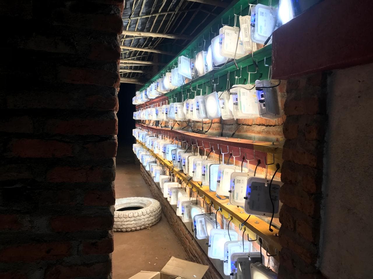Rows of Quadloop solar lanterns lit in a workshop