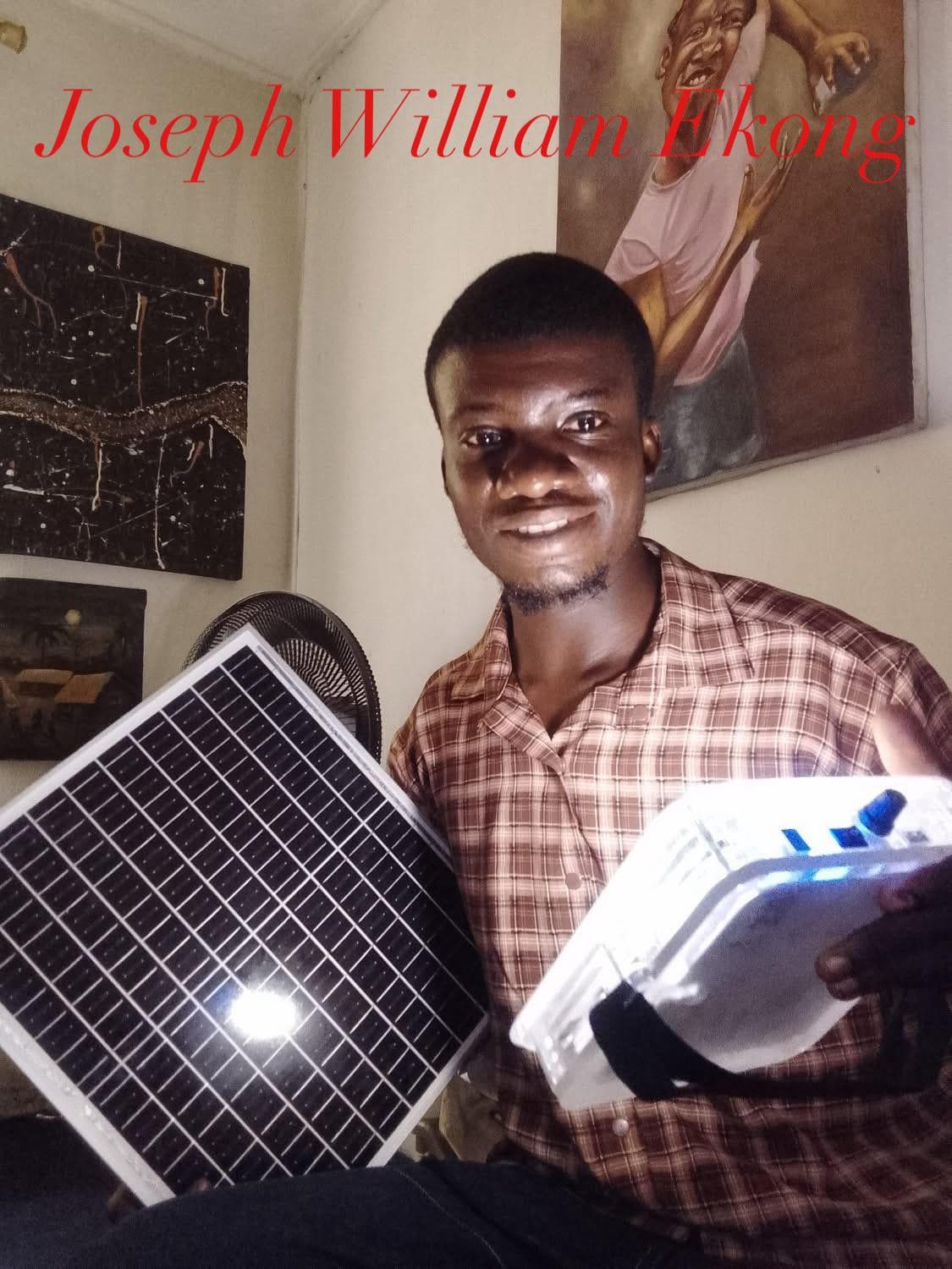 Artist Joseph William Ekong holding a Quadloop solar panel and lantern.